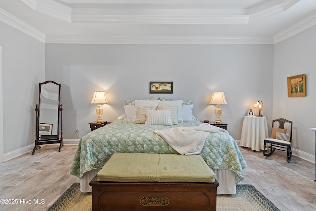 2402 W Oak Island Dr, Oak Island, NC 28465 - bedroom with a raised ceiling, light wood-style floors, ornamental molding, and baseboards