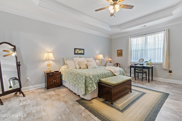 2402 W Oak Island Dr, Oak Island, NC 28465 - bedroom with a tray ceiling, ornamental molding, light wood-type flooring, baseboards, and ceiling fan