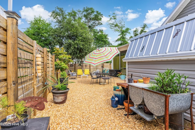 2402 W Oak Island Dr, Oak Island, NC 28465 - fenced backyard with outdoor dining space and a patio