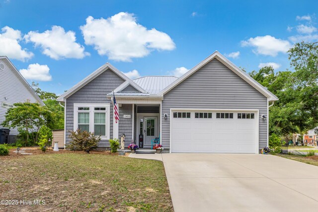 2402 W Oak Island Dr, Oak Island, NC 28465 - ranch-style home featuring an attached garage, concrete driveway, a front lawn, and metal roof