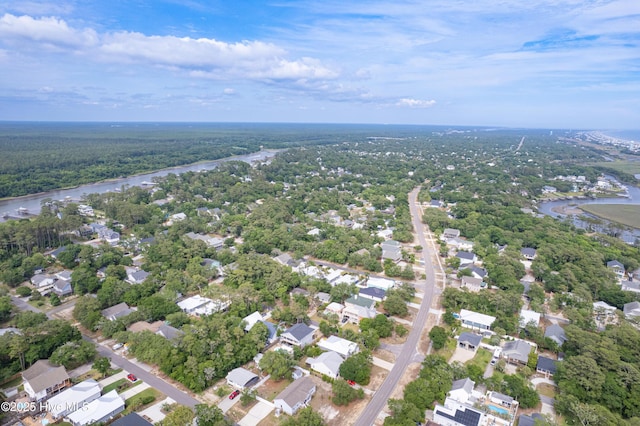 2402 W Oak Island Dr, Oak Island, NC 28465 - aerial view of property's location with a nearby body of water, nearby suburban area, and a forest