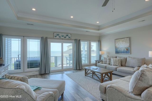 876 Villas Dr, North Topsail Beach, NC 28460 - living room featuring a raised ceiling, wood finished floors, a ceiling fan, recessed lighting, and ornamental molding