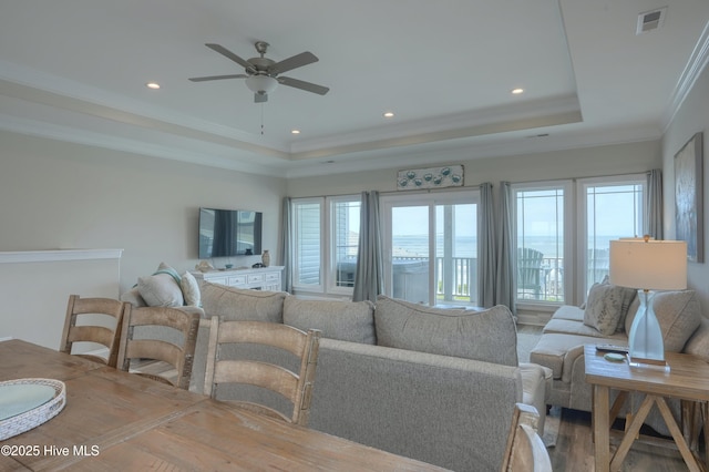 876 Villas Dr, North Topsail Beach, NC 28460 - living area featuring a raised ceiling, a ceiling fan, recessed lighting, ornamental molding, and wood finished floors