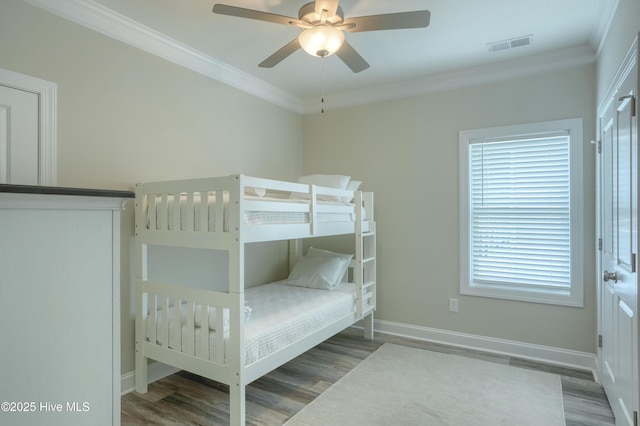 876 Villas Dr, North Topsail Beach, NC 28460 - bedroom with wood finished floors, ornamental molding, baseboards, and a ceiling fan