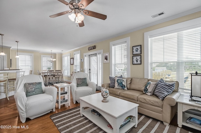 2 Clam Shell Ln Unit 6, Carolina Beach, NC 28428 - living room with ornamental molding, ceiling fan, wood finished floors, and a chandelier