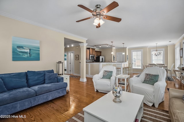 2 Clam Shell Ln Unit 6, Carolina Beach, NC 28428 - living room featuring ornamental molding, a ceiling fan, wood finished floors, baseboards, and a chandelier
