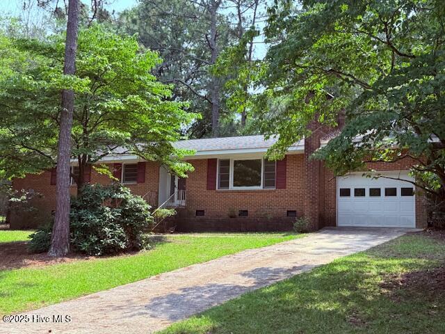 430 W Rhode Island Ave, Southern Pines, NC 28387 - single story home featuring crawl space, driveway, brick siding, a front lawn, and an attached garage