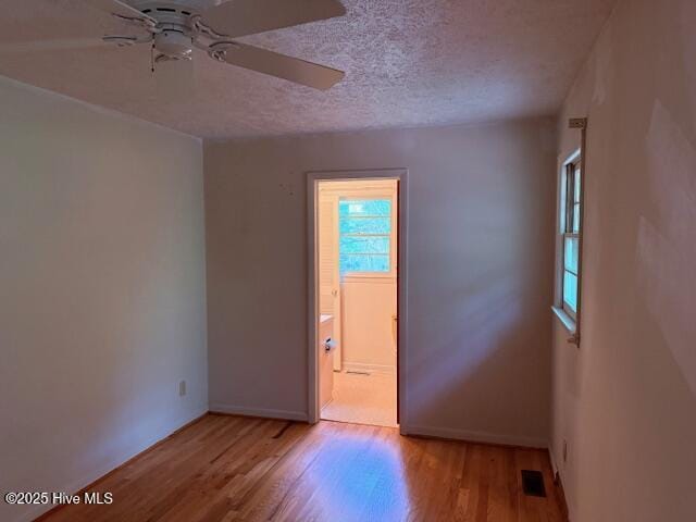 430 W Rhode Island Ave, Southern Pines, NC 28387 - spare room featuring ceiling fan, wood finished floors, a textured ceiling, and baseboards