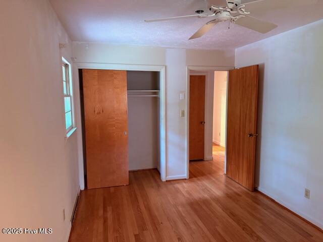430 W Rhode Island Ave, Southern Pines, NC 28387 - unfurnished bedroom featuring light wood-type flooring, a closet, a ceiling fan, and baseboards