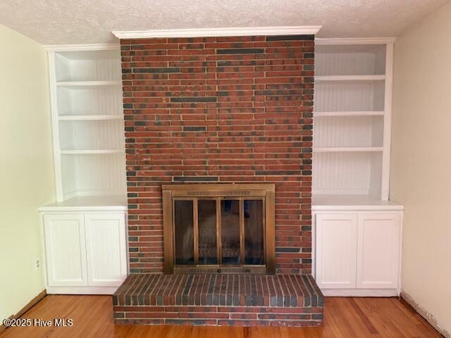 430 W Rhode Island Ave, Southern Pines, NC 28387 - detailed view of a fireplace, wood finished floors, a textured ceiling, and built in features