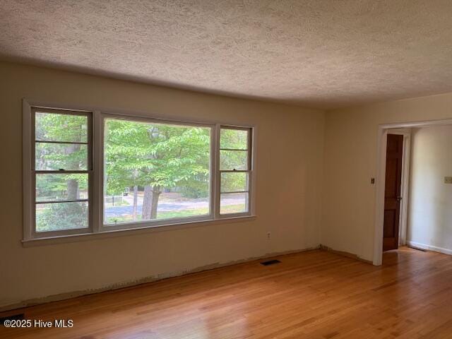 430 W Rhode Island Ave, Southern Pines, NC 28387 - empty room featuring a textured ceiling and light wood-type flooring