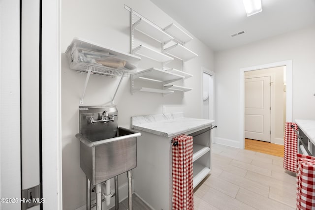 103 Schever Rd, West End, NC 27376 - washroom featuring a sink, light wood-type flooring, and baseboards
