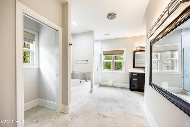 103 Schever Rd, West End, NC 27376 - full bath with vanity, a shower stall, a bath, stone finish flooring, and baseboards