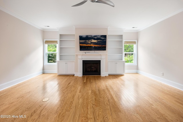 103 Schever Rd, West End, NC 27376 - unfurnished living room with baseboards, a ceiling fan, a fireplace, light wood-style floors, and crown molding