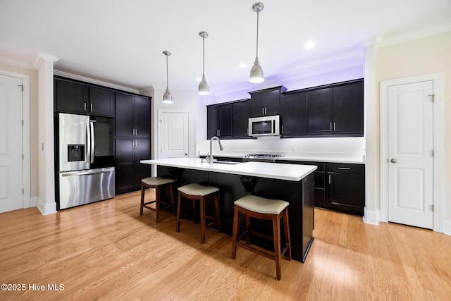 103 Schever Rd, West End, NC 27376 - kitchen with appliances with stainless steel finishes, a sink, crown molding, a kitchen breakfast bar, and dark cabinetry