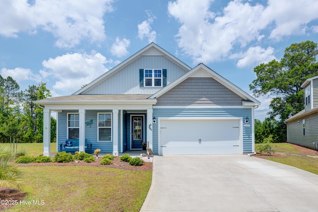 1337 Fence Post Ln, Carolina Shores, NC 28467 - view of front of property with concrete driveway, a front yard, a porch, and an attached garage