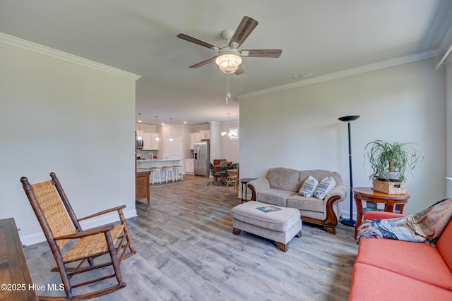 1337 Fence Post Ln, Carolina Shores, NC 28467 - living area featuring ceiling fan, light wood-style flooring, ornamental molding, and baseboards