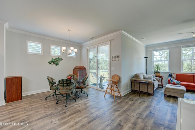 1337 Fence Post Ln, Carolina Shores, NC 28467 - dining area featuring wood finished floors, baseboards, crown molding, a chandelier, and ceiling fan