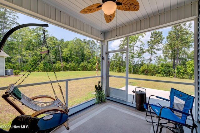 1337 Fence Post Ln, Carolina Shores, NC 28467 - sunroom with a ceiling fan and view of wooded area
