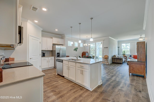 1337 Fence Post Ln, Carolina Shores, NC 28467 - kitchen with appliances with stainless steel finishes, a sink, ornamental molding, white cabinets, and light wood-style floors