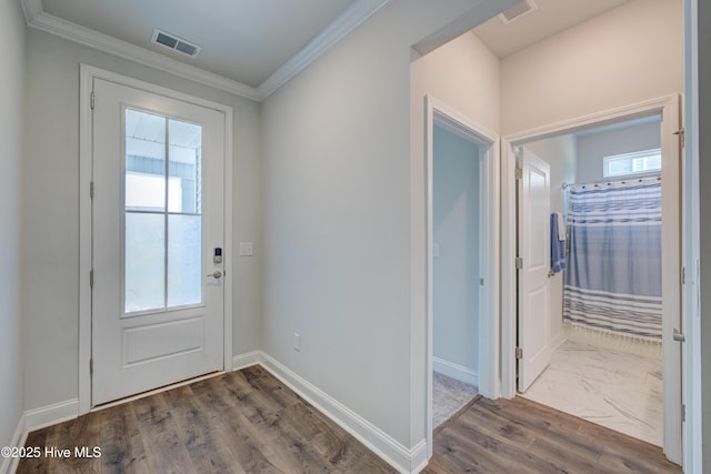 1337 Fence Post Ln, Carolina Shores, NC 28467 - doorway to outside featuring healthy amount of natural light, baseboards, and ornamental molding