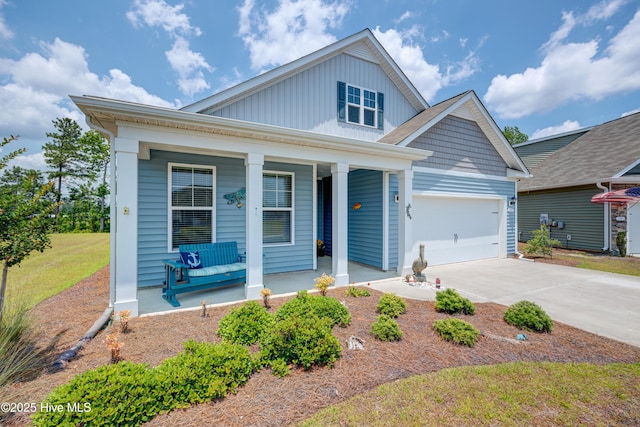 1337 Fence Post Ln, Carolina Shores, NC 28467 - view of front of home with a porch, driveway, board and batten siding, and an attached garage