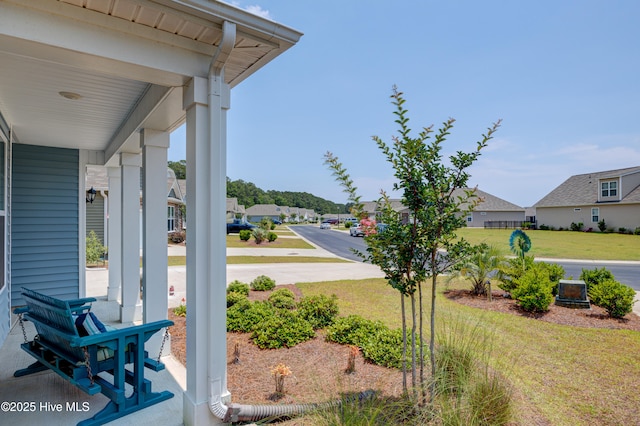 1337 Fence Post Ln, Carolina Shores, NC 28467 - view of grassy yard with a porch and a residential view
