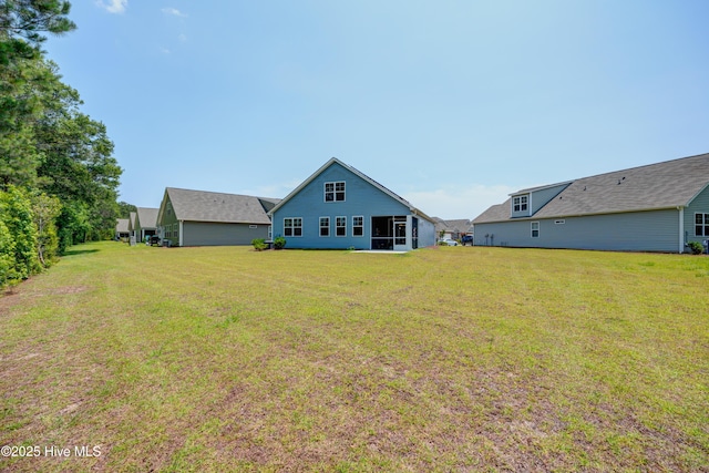 1337 Fence Post Ln, Carolina Shores, NC 28467 - rear view of house with a yard