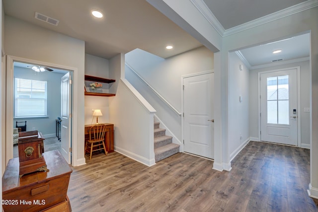 1337 Fence Post Ln, Carolina Shores, NC 28467 - foyer entrance featuring ornamental molding, wood finished floors, baseboards, plenty of natural light, and recessed lighting