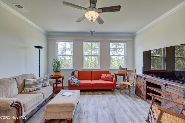 1337 Fence Post Ln, Carolina Shores, NC 28467 - living area featuring plenty of natural light, light wood-style floors, ornamental molding, and ceiling fan