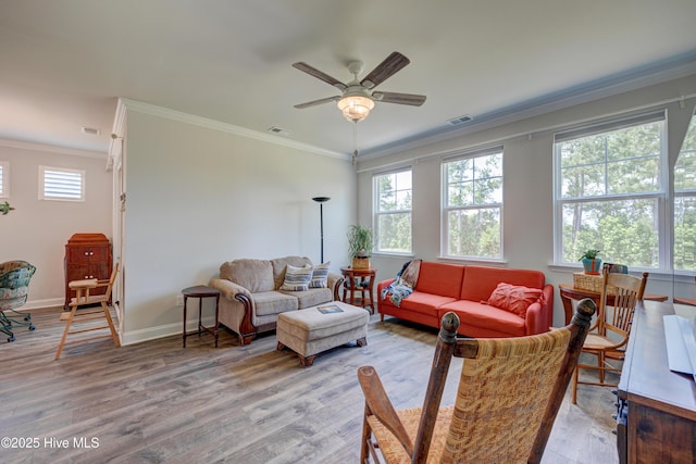1337 Fence Post Ln, Carolina Shores, NC 28467 - living room with ornamental molding, light wood-type flooring, ceiling fan, and baseboards