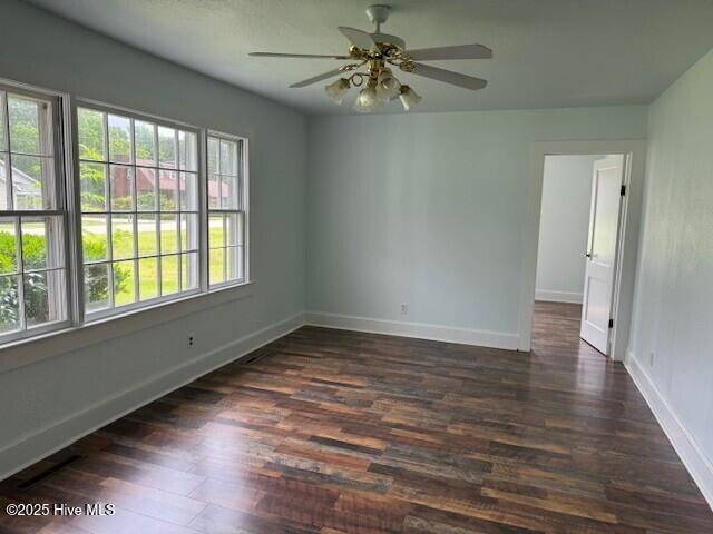 214 NC Highway 561 E, Ahoskie, NC 27910 - unfurnished room featuring dark wood finished floors, baseboards, and ceiling fan