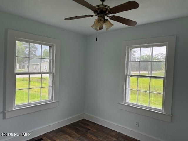 214 NC Highway 561 E, Ahoskie, NC 27910 - spare room with baseboards, dark wood-style flooring, and a ceiling fan