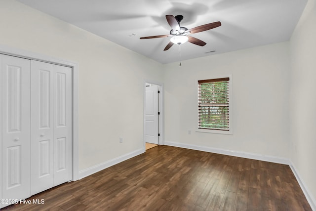 1120 Beasley Rd, Wilmington, NC 28409 - unfurnished bedroom featuring dark wood finished floors, a closet, and ceiling fan