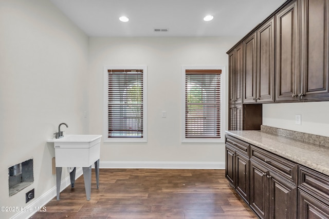 1120 Beasley Rd, Wilmington, NC 28409 - laundry room with dark wood-style flooring and recessed lighting