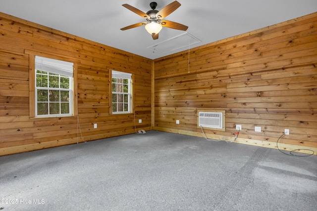 1120 Beasley Rd, Wilmington, NC 28409 - spare room featuring attic access, a wall mounted AC, carpet flooring, a ceiling fan, and wood walls