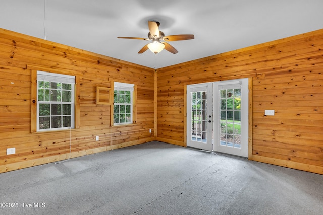 1120 Beasley Rd, Wilmington, NC 28409 - carpeted empty room featuring ceiling fan and wood walls