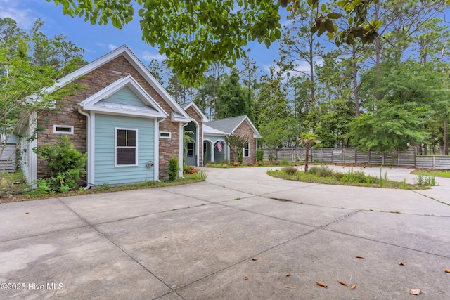1120 Beasley Rd, Wilmington, NC 28409 - view of front of property featuring stone siding and concrete driveway