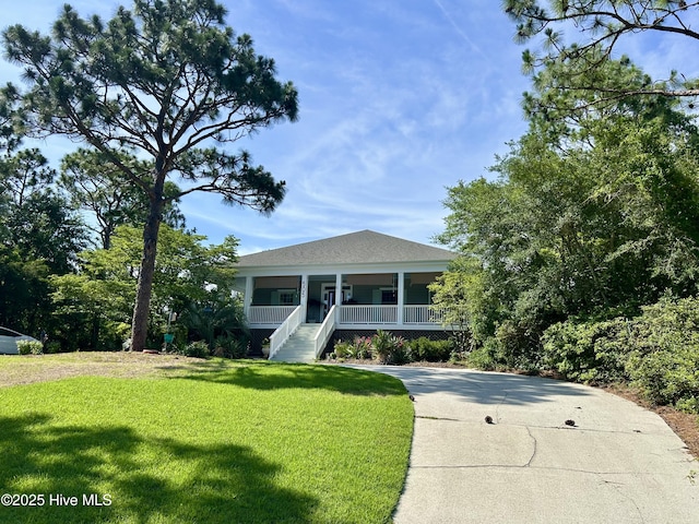 505 Rivage Promenade, Wilmington, NC 28412 - view of front facade featuring a front yard, covered porch, and stairs
