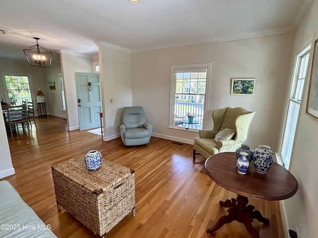 505 Rivage Promenade, Wilmington, NC 28412 - living room with light wood finished floors, crown molding, and a chandelier