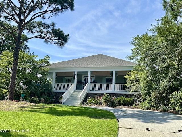 505 Rivage Promenade, Wilmington, NC 28412 - view of front facade with a porch, a front yard, stairway, and driveway