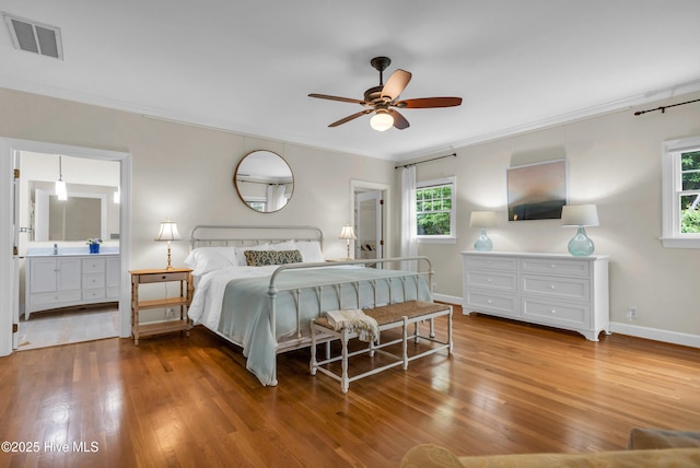 505 Rivage Promenade, Wilmington, NC 28412 - bedroom with wood finished floors, crown molding, and connected bathroom