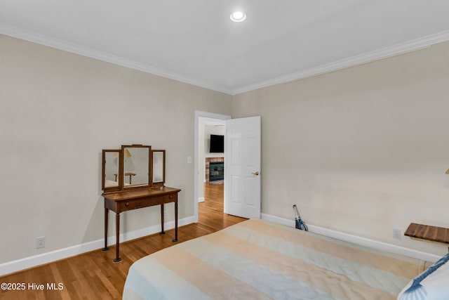505 Rivage Promenade, Wilmington, NC 28412 - bedroom featuring wood finished floors, crown molding, a fireplace, and recessed lighting