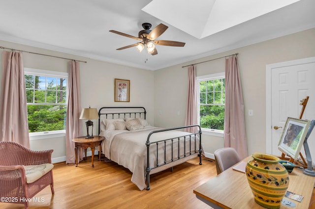 505 Rivage Promenade, Wilmington, NC 28412 - bedroom featuring multiple windows, light wood-style flooring, ornamental molding, and a ceiling fan