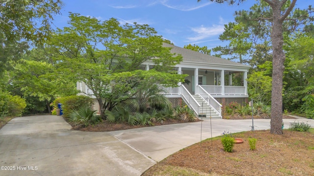 505 Rivage Promenade, Wilmington, NC 28412 - view of front of house with stairs, covered porch, driveway, and roof with shingles