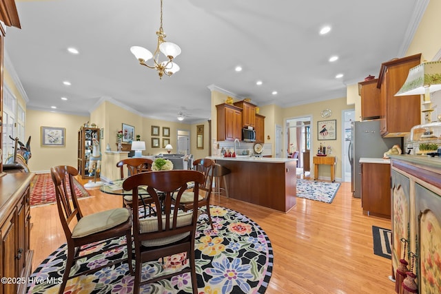 155 Mckenzie Rd E, Pinehurst, NC 28374 - dining space featuring crown molding, light wood finished floors, a chandelier, recessed lighting, and ceiling fan