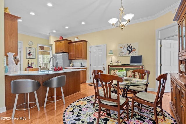 155 Mckenzie Rd E, Pinehurst, NC 28374 - dining room featuring ornamental molding, light wood-style floors, a chandelier, recessed lighting, and baseboards