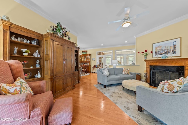 155 Mckenzie Rd E, Pinehurst, NC 28374 - living room with crown molding, light wood finished floors, ceiling fan, a fireplace, and recessed lighting