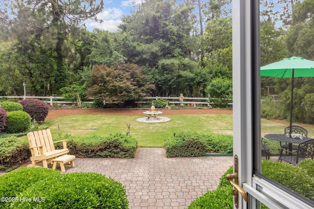 155 Mckenzie Rd E, Pinehurst, NC 28374 - view of yard featuring a patio and view of wooded area