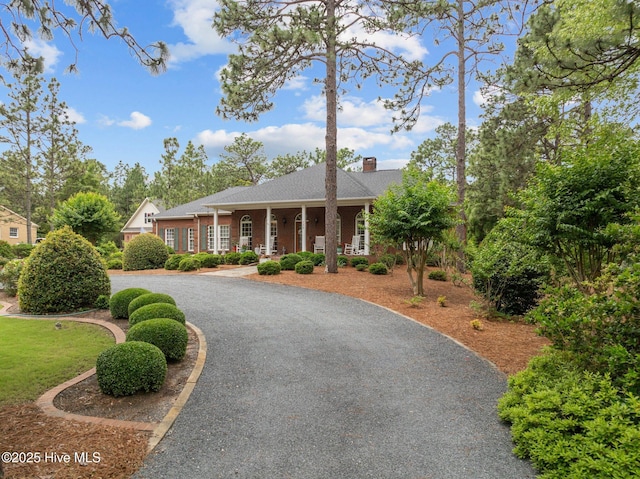 155 Mckenzie Rd E, Pinehurst, NC 28374 - view of front of home featuring a porch and a chimney